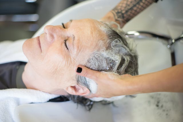 senior woman getting her hair done in a care home salon